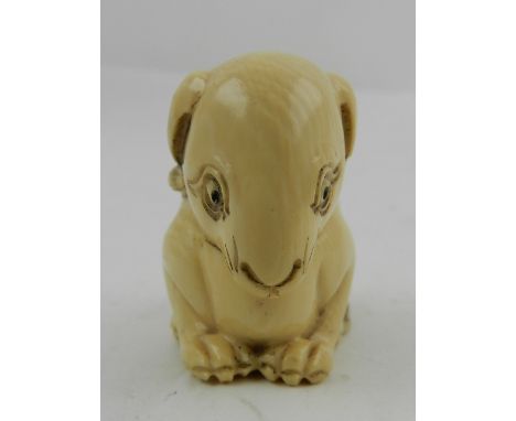 A Japanese ivory netsuke of a lion, signed to base. H: 4cm