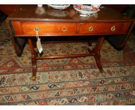 A Regency style mahogany sofa table, having two drop ends, fitted two single drawers, raised on lyre supports joined by a tur