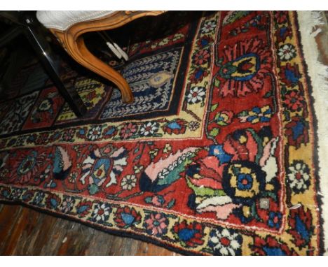 A carpet, possibly Turkish (?), the centre having four rows of squares having floral decoration, multi-bordered and fringed. 