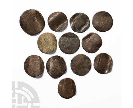 Circa 18th century A.D.. Mixed group comprising of mostly silver issue coins, each worn flat and coin bent into a double-curv