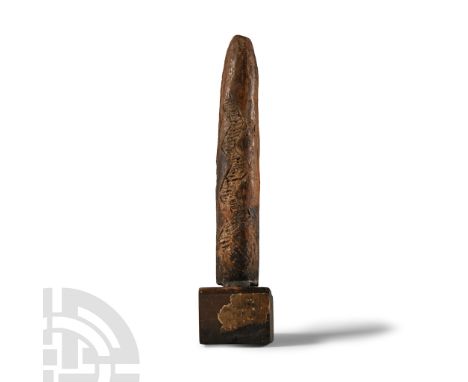 2100-1850 B.C.. Tapering round-section votive with reserved zigzag bands of dense linear hatching; remains of an old base inc