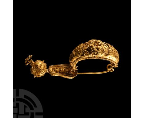 7th century B.C.. Hollow-formed bow with applied floral detailing, filigree and granules, double-coiled spring and pin; tongu