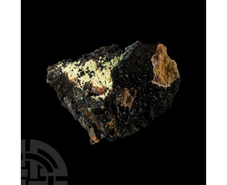Well-formed crystals on a matrix of brownish black limonite, the crystals coated, in certain areas, by very small, translucen
