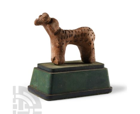 Early Bronze Age, circa 2500-2000 B.C.. Modelled in the round with fleece texture to the back and rump, applied eyes and horn