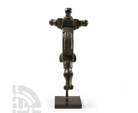 Later 5th century A.D.. A bronze cruciform brooch of early type comprising: square headplate with rectangular wings and three