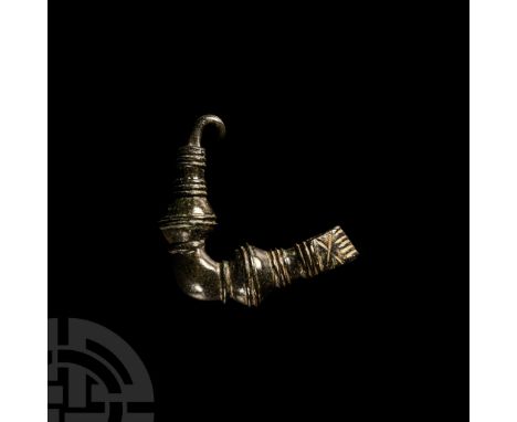 Circa 7th-5th century B.C.. The bow decorated with circumferential grooves, one arm ending with the partially preserved wire 