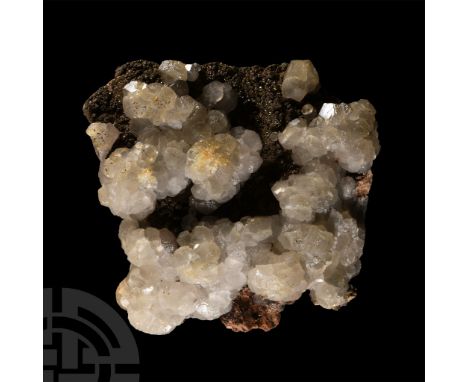 Greyish, imperfect calcite crystals on a bed of small iridescent pyrite crystals, collection number 517.  698 grams, 10.8 cm 
