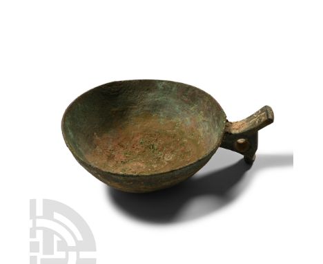 2nd-1st millennium B.C.. Comprising a broad shallow bowl and integral handle with thumb-pad and spur beneath, pierced lateral