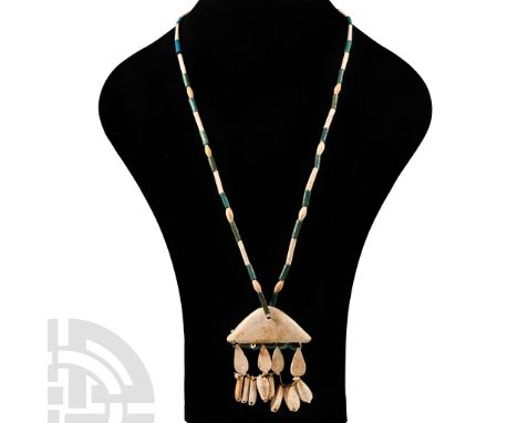 1400-1100 B.C.. Alternating white and turquoise tubular beads with oval spacer bead; a collar terminal as a central pendant w
