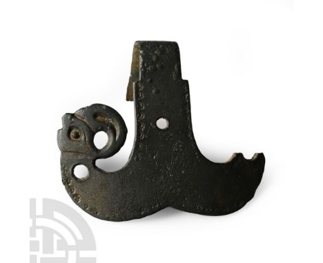6th century A.D.. Pelta-shaped with scrolled avian heads (one absent), punched detailing to edges, retaining strap and hole f