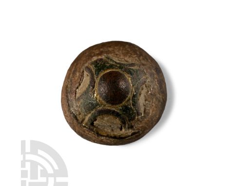 9th-11th century A.D.. Domed bronze stud with traces of gilding and enamel, silver stud at apex; embedded in a circular block
