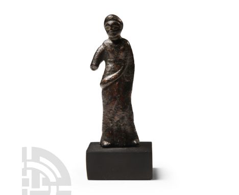 3rd-1st century B.C.. Modelled in the round, standing with peplos dress and a large stola draped over the left shoulder and a