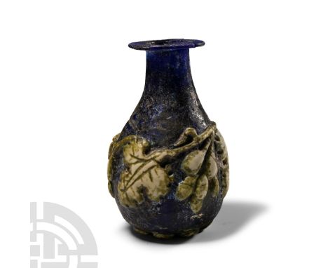 Early 1st century A.D. and later. Of piriform shape with iridescent surfaces, decorated with later applied fruiting vines in 
