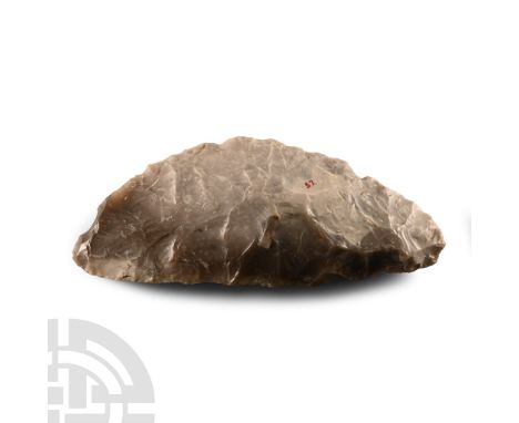 Neolithic Period, circa 2500-1500 B.C.. With lentoid section and long curved cutting edge; collector's inked number '57'. Cf.