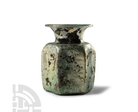 1st-3rd century A.D.. Squat hexagonal-section jar with pinched angles, flared mouth and rolled rim. Cf. Whitehouse, D., Roman