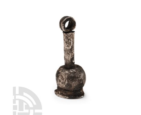 Late Period, 664-332 B.C.. With bulb and disc finial, integral shank and gusseted suspension loop. Cf. Andrews, C., Amulets o