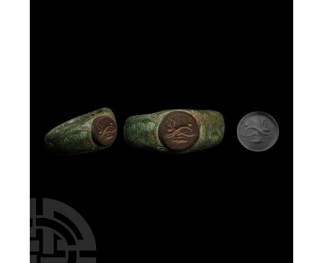 3rd century A.D.. With lateral carinations and inset glass intaglio of a dolphin breasting the waves; supplied with a museum-