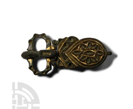 6th-7th century A.D.. Comprising: buckle loop with dentilled outer edge, impressed triangular cells; D-section tongue curved 