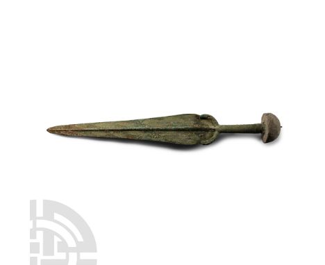 Late 2nd-early 1st millennium B.C. The hilt with mushroom-shaped pommel, round grip, crescentic guard, long sloping blade wit