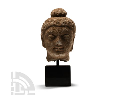 2nd-4th century A.D.. Modelled in the round with fleshy facial features, arched brows, long earlobes, ushishna above; mounted