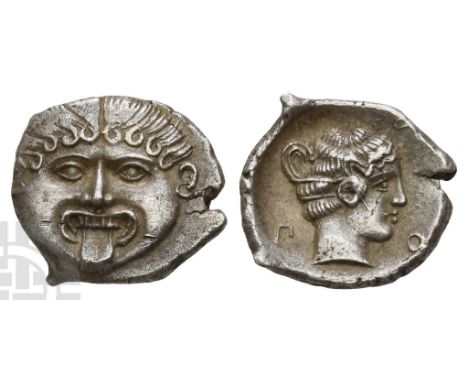 Circa 375-350 BC.. Facing gorgoneion, with tongue protruding / Head of nymph to right, her hair coiled around her head and wi