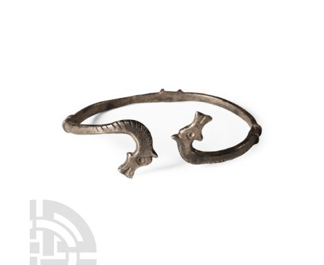 3rd-4th century A.D.. Penannular bracelet with D-section shank, paired projecting flanges, horse-head finials placed tête-bêc