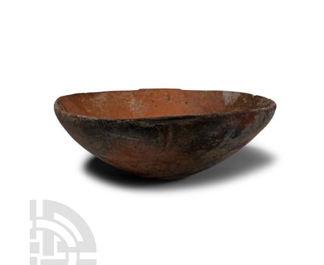 Late Bronze Age, circa 1450-1200 B.C.. Broad squat bowl with dished profile, rounded rim, single pierced ledge handle; with i