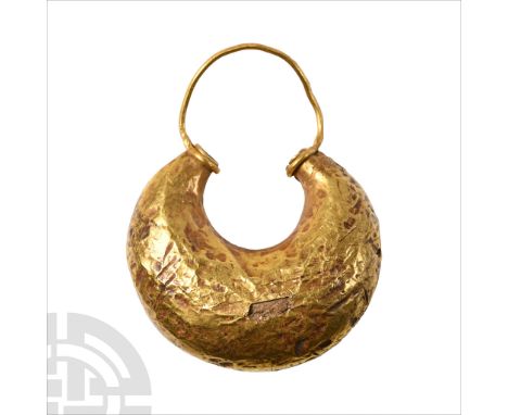 Circa 8th century B.C.. Comprising a tapering hoop with applied filigree collars, wire hoop. Cf. Williams, D. &amp; Ogden, J.