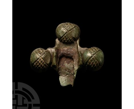9th-11th century A.D.. Cruciform mount with three radiating lobes and a fourth slotted section; each lobe with separately cas