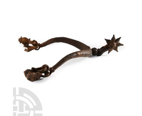 Circa 14th century A.D.. Comprising a U-shaped shank with carinated outer face, locket to each finial, ball and curved arms s