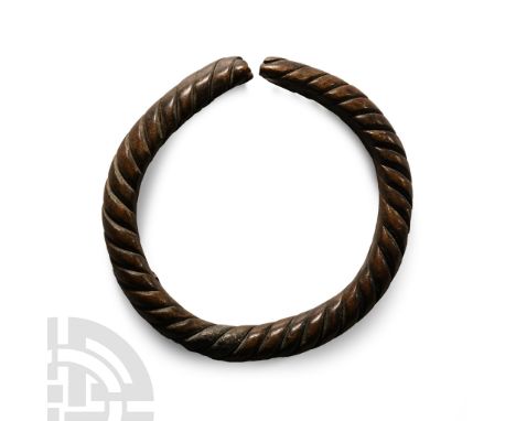 Circa 9th-11th century A.D.. Formed from three round-section rods twisted around each other; clubbed ends. Cf. twisted bracel