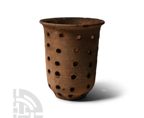 Bronze Age, 2300-1650 B.C.. Tall and bell-shaped with rows of piercings.  175 grams, 11 cm (4 1/4 in.). From a collection acq