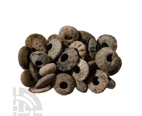 12th-16th century A.D.. Mainly biconvex in profile with raised pellet and other detailing; many of these objects are publishe