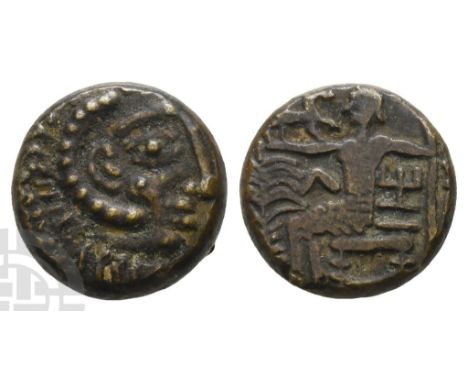Circa 1st century BC - 2nd century AD.. Head of Herakles to right, wearing lion skin headdress / Figure seated to left, holdi