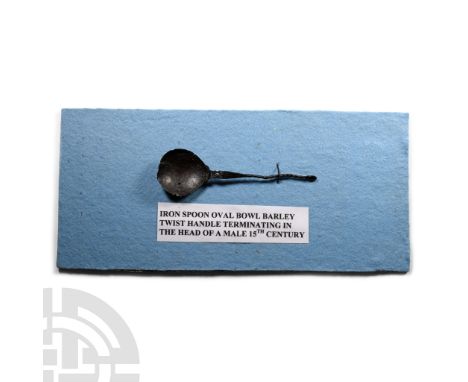 Circa 14th-16th century A.D.. A spoon with broad bowl and barley twist handle and face to the finial, mounted on a fabric-cov
