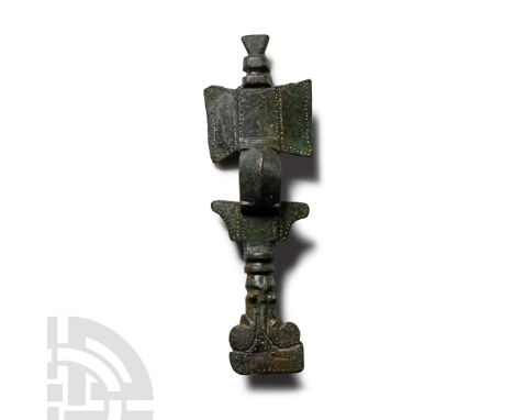 6th century A.D.. Comprising a rectangular headplate flanked by lateral trapezoidal wings and with a stepped knop above, cari