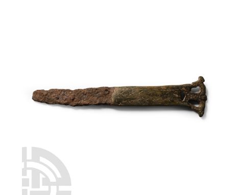 Circa 2nd-3rd century A.D.. Single-edged iron blade with ellipsoid-section bronze handle, openwork acanthus-leaf finial, band