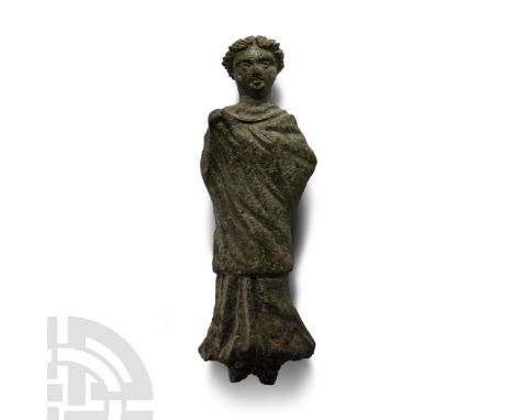 3rd-2nd century A.D.. Female with hair drawn up in a chignon, palla wrapped tightly around the upper body hiding the right ar