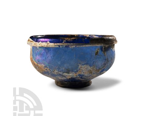 1st-2nd century A.D.. Shallow in profile with basal ring, iridescent surface, applied collar below the rim; old collector's l
