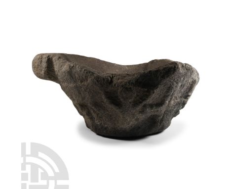 Circa 14th-15th century A.D.. Squat in profile with foliage and scrolls to the sidewall, deep bowl and pouring lip.  6.25 kg,