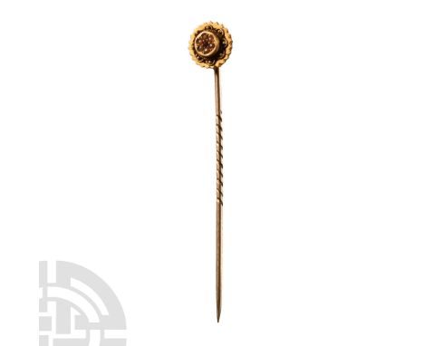 Mid 20th century A.D.. Comprising a slender shank with incised running spiral. perpendicular mounted disc with dentilled rim,