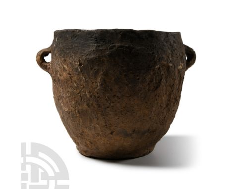 Late Bronze Age, 1200-750 B.C.. Barrel-shaped in profile with chamfered rim and two lateral loop handles below.  676 grams, 1