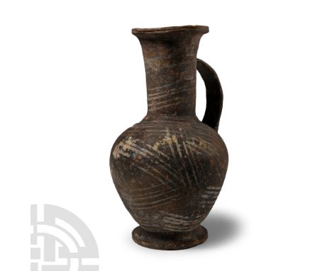 Late Bronze Age, circa 1450-1200 B.C.. Comprising a piriform body and flared base with outer thickened rim, collar to the sho