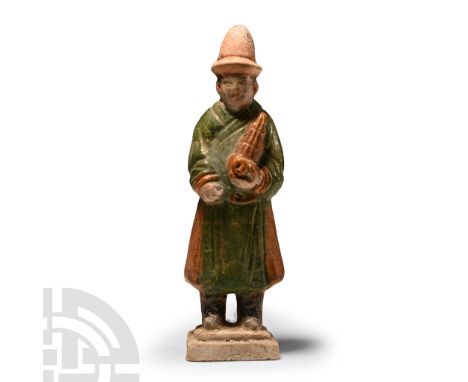 Ming Dynasty, 1368-1644 A.D. or later. Modelled in the round wearing a red conical hat with upturned brim, black boots and th