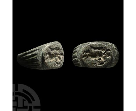 2nd-3rd century A.D.. Ribbed shoulders and ellipsoid plaque with intaglio winged Victory standing holding an effigy in her ou
