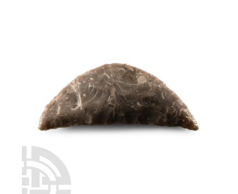 Neolithic Period, circa 2500-1500 B.C.. With lentoid section and curved back and ribbed cutting edge; rounded recess close to