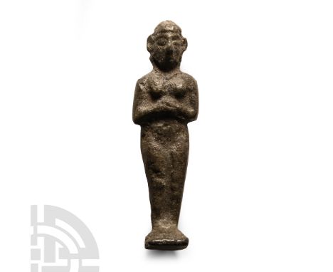 6th-4th century B.C.. Modeled in the round with arms folded across the abdomen, standing nude on a square base.  107 grams, 9