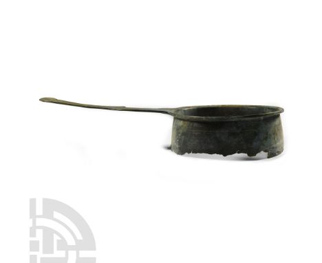 2nd-3rd century A.D.. With a deep bowl, everted rim with a rounded lip, flat-section handle with lateral spurs and oval finia