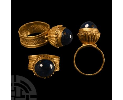 5th-6th century A.D.. Flat-section hoop displaying geometric pierced work between raised bands, fluted hemispherical bezel ad