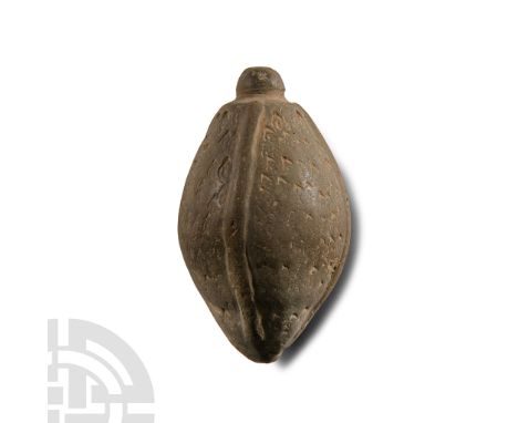 12th-13th century A.D.. Piriform body with domed filler-hole, the surface divided by four long grooves united at the bottom, 
